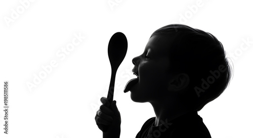 A silhouette of a young boy holding a spoon and sticking out his tongue in a playful pose