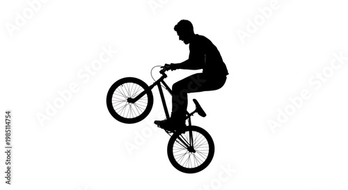 A silhouette of a man riding a bicycle in a dynamic pose