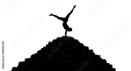 A silhouette of a woman doing a handstand on a pyramid
