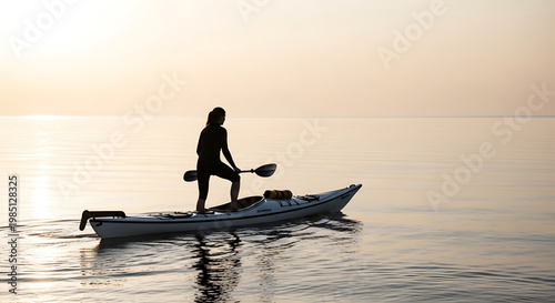 A serene woman kayaking on calm waters during a peaceful sunset