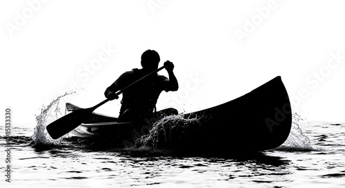 A man paddles a canoe through the water in a serene and peaceful environment.