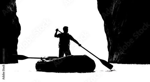 A silhouette of a man paddling a kayak through a narrow passageway between two large rocks