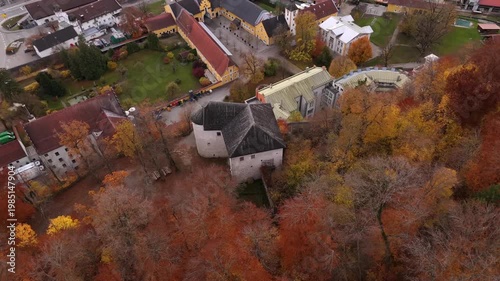Aerial shot of Schloss Stein an der Traun, Bavaria, Germany. Medieval rock castle and cave fortress surrounded by colorful autumn forest. Historic fortress on Nagelfluhwand above Traun valley
