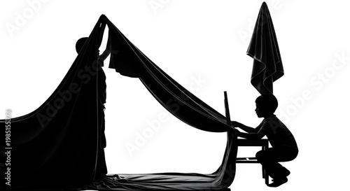 A silhouette of a person setting up a hammock in a peaceful outdoor setting