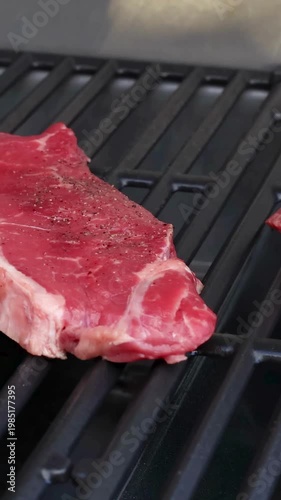 Grilling Fresh Beef Steaks on Barbecue Grill.