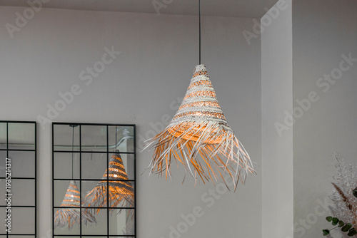 фотографія decorative pendant light fixture made from woven vegetable fibers, likely rattan