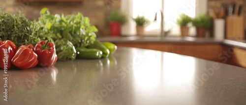 Fresh red and green peppers, leafy herbs on a speckled kitchen counter, with a blurred modern kitchen in the background