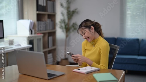 Young Woman Using Smartphone in Modern Office Setting