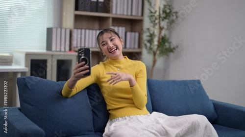 Young Woman Enjoys Video Call in Bright Modern Living Room Decor