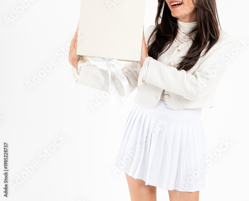 Asian woman body in white short skirt holding plain gift box, isolated on white background