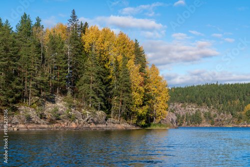Small rocky islands in narrow bays in the Ladoga Skerries National Park, near the village of Lumivaara, on a sunny autumn day, Republic of Karelia, Russia