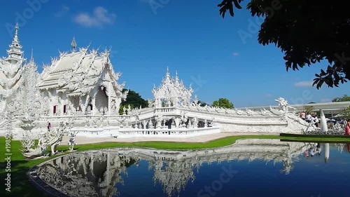 Wat Rong Khun White Temple in Chiang Rai Thailand with Reflection Pond and Blue Sky