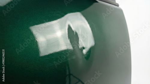 Green car body dent insurance accident estimate damage closeup panel scratch
