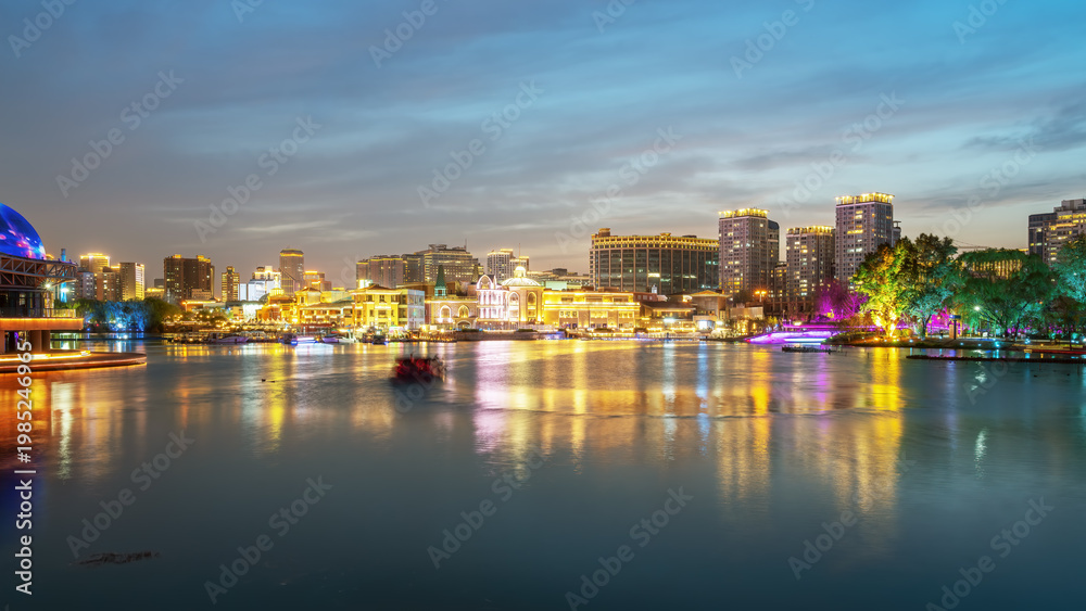 Obraz premium Night View of Modern City Waterfront with Lights