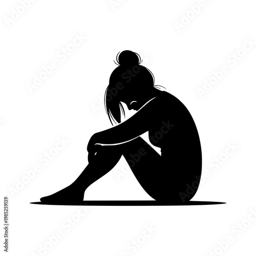 Silhouette of a sad and lonely woman sitting on the floor