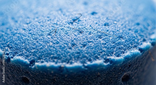 Detailed Shot of a Blue Kitchen Whisk Covered in Fine White Powder
