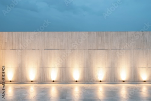 Concrete wall illuminated by warm architectural spotlights provides a minimalist and textured background that is perfect for displaying text or branding elements in a professional setting.