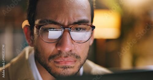 Confused, man and laptop in office at night for bad news, online criticism and article error. Worry, male person and pc with negative feedback, false source and missed deadline for story publication