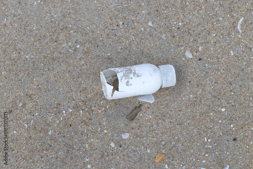 Plastic water bottles thrown on the sand, plastic pollution and broken bottle. Climate change issues with the plastic wastes and bottle waste.