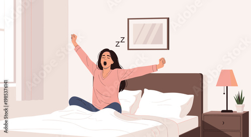 Tired young woman sitting in her comfortable bed yawning and stretching her arms after waking up in the morning.