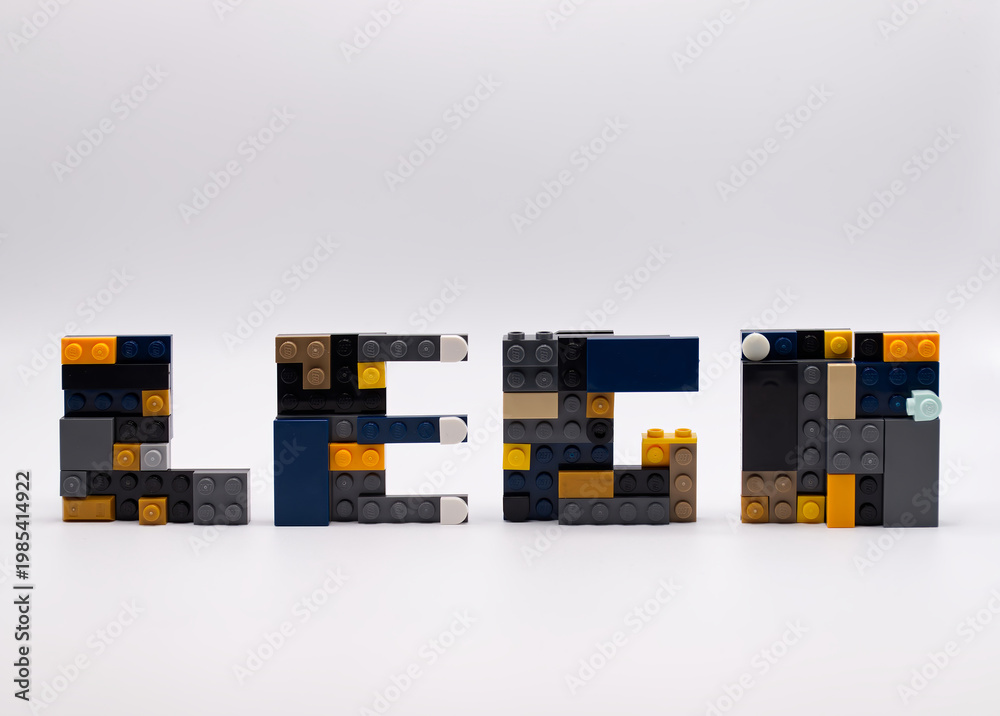 Fototapeta premium Bologna - Italy - April 14, 2026: The word LEGO spelled out using various colorful plastic building blocks on white background.