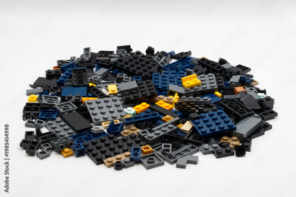Obraz premium Bologna - Italy - April 14, 2026: Large pile of diverse plastic LEGO building blocks isolated on white background.