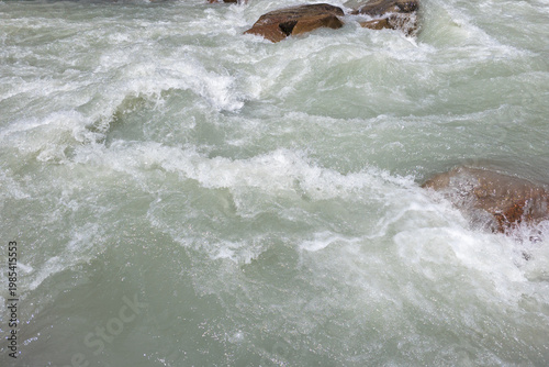 Dynamic river rapids flowing through Kyrgyzstan's nature