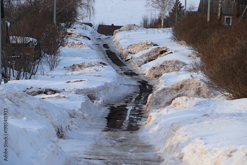 Early spring in a Russian village, rural road, spring thaw