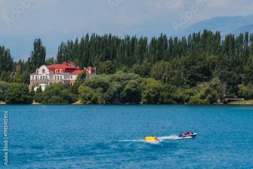 Three adults enjoying recreation on lake in motorboat
