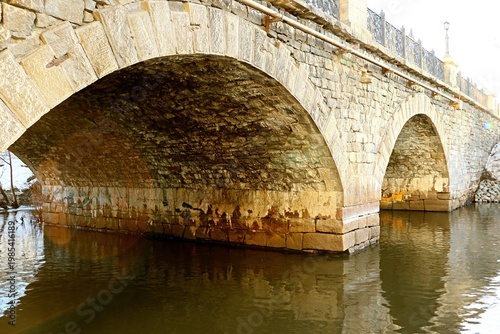 An ancient stone bridge with arched spans
