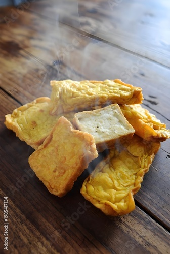 Hot Crispy Golden Fried Tofu Snacks Steaming On A Rustic Wood Table Background