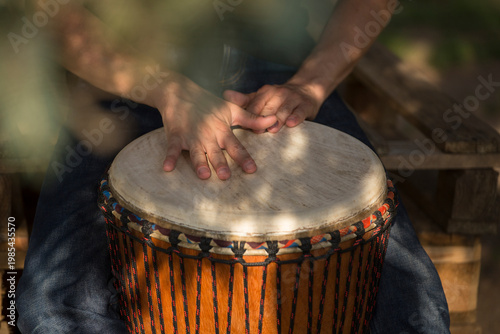 Playing at djembe drum outdoor, having a good time. Rythm and sound