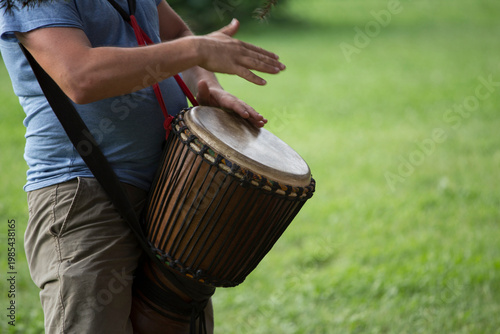 Playing djembe drum outdoor, having a good time. Rythm and sound play