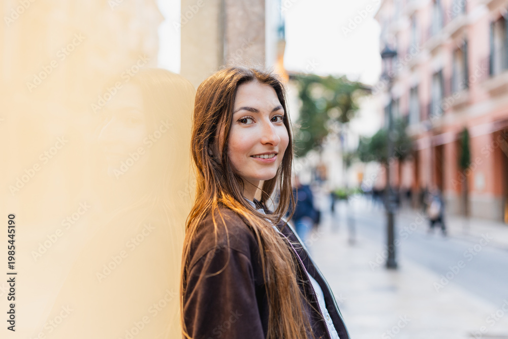 Fototapeta premium Young woman smiling in urban street lifestyle