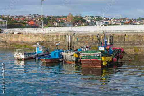 Shellfish boats docked at the Canido pier in Vigo with their traps ready for shellfish harvesting.