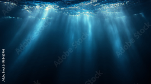 Abstract underwater light rays shining through deep blue water creating a calm atmosphere.