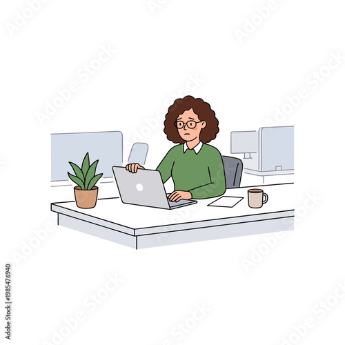 A woman works on her laptop at a desk in an office.