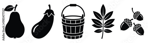 Black silhouettes of various harvest elements including a pear, eggplant, wooden bucket, leafy branch, and acorns suitable for seasonal graphic compositions, educational resources, or