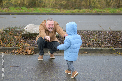 Grandfather Welcoming Toddler During Winter