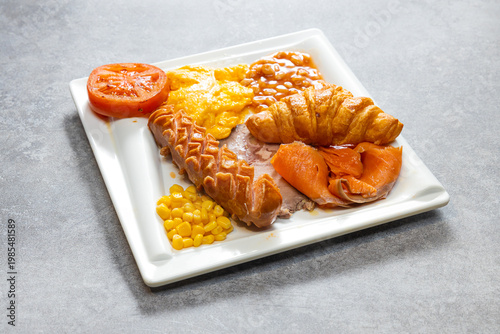 Hearty breakfast plate with sausage croissant