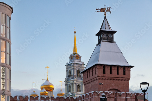 Golden domes glow against clear blue sky