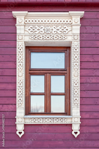 Elegant carved wood frames grace a vibrant purple wall