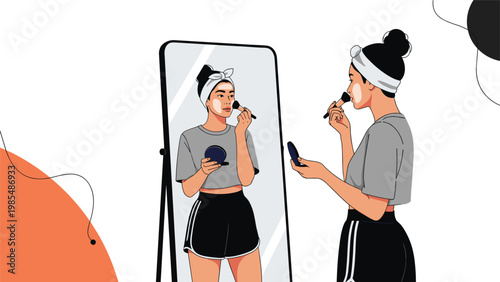 Beautiful young woman applies foundation to her face while looking into a tall mirror in a stylishly lit bedroom.