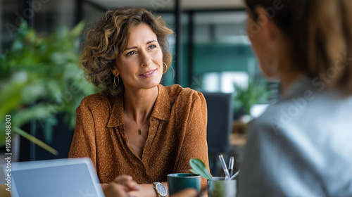 Female founder coach conducting a one on one coaching consultation with a single niche client in a professional business setting supportive mood