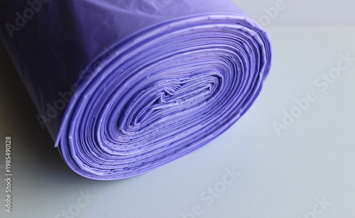 Close up of End of a Roll of Violet Trash Bags Isolated On White
