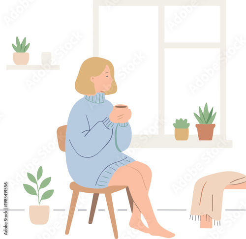 Woman sits on chair holding cup by window with plants around her