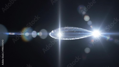 Elegant lens flare on black backdrop concept. Bright glowing light flare with colorful lens reflections on dark background for abstract design