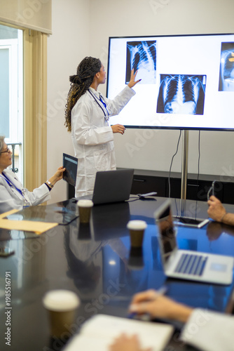 Doctor presenting x ray images during medical briefing