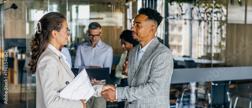 Bilde på lerret White female executive greeting black entrepreneur with handshake