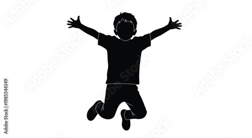 Silhouette of a young boy jumping with arms outstretched in joy